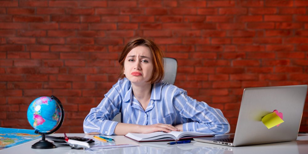 front-view-sad-travel-agent-her-working-place-map-service-assistant-agency-indoors-manager-operator-world